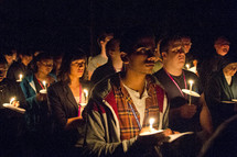 holding candles during a prayer vigil 