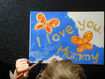 child painting a picture for mommy, 
picture, butterflies, Mother's Day, paint, painting, paintbrush, brush, yellow, orange, red, golden, present, gift, love, Mother's Day, mother's day, mom, mother, mummy, mum, mommy, nice, lovely, fine, pleasant, fair, pretty, color, colour, colorful, multicolored, blue, sky, mother’s day, holiday, holidays, holidays: