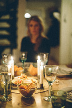 woman sitting at a dinner table 