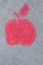 red apple in sidewalk chalk 