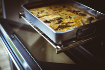 a casserole in a pan in an oven 