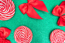 Flatlay of some red Christmas decoration, on a green background. Background for Christmas.