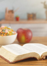 A Bible on a Wooden Table with Breakfast Set a Perfect Way to Start Your Day