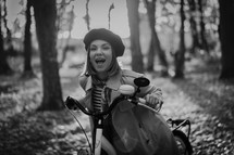 Beautiful dreamy portrait of young smiling woman in french beret cycling alone in park. Sunny day in forest. Trendy lady on vintage bicycle, healthy lifestyle, aesthetic scene. High quality photo
