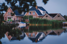 House by the canal and boat in the water