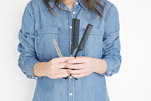 hairdresser holding scissors and combs 