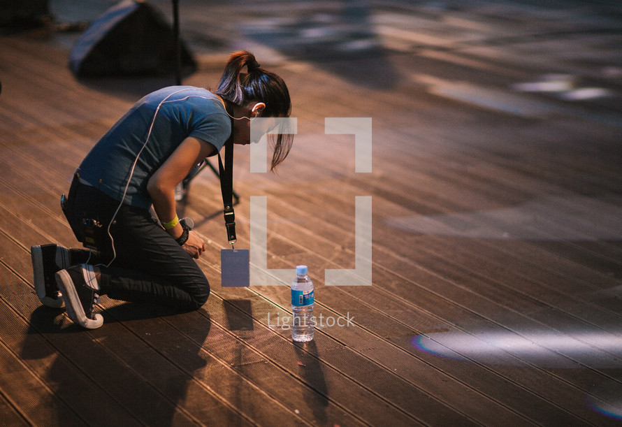 a woman kneeling down on stage 
