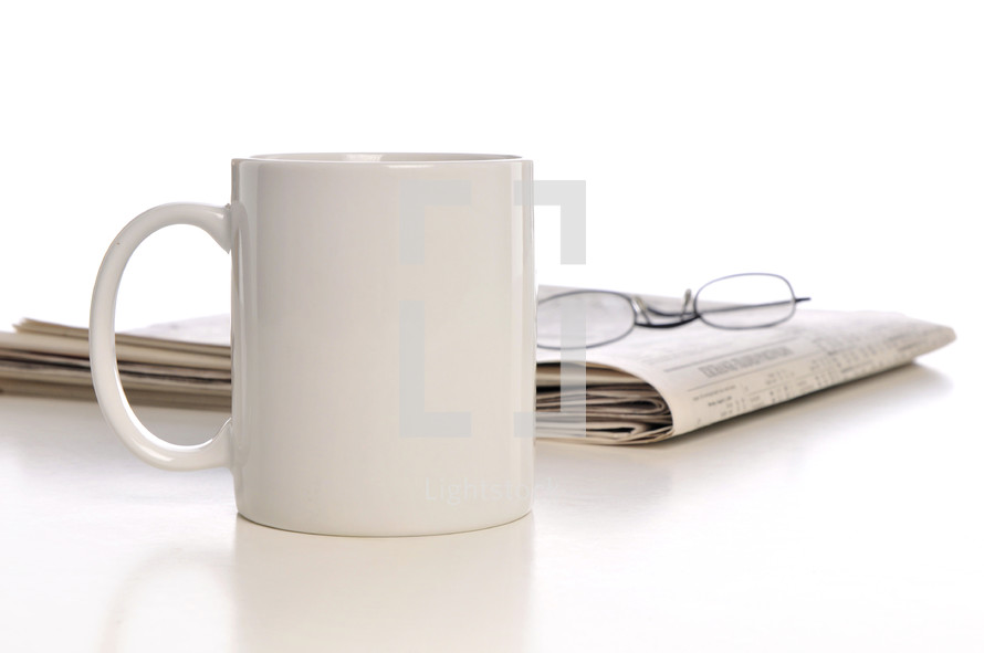 coffe mug, newspaper, and reading glasses 