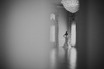 bride standing in the light of a window