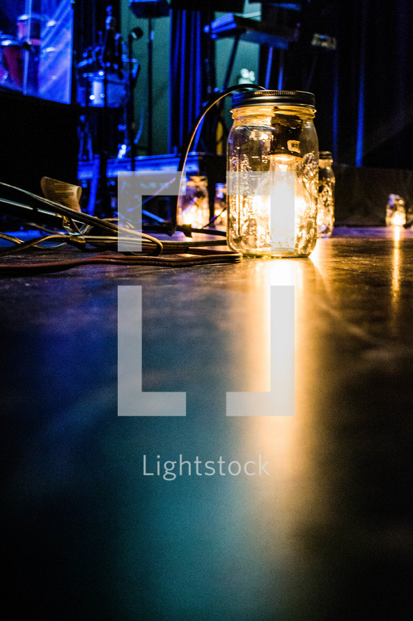 lightbulb in a jar on a stage