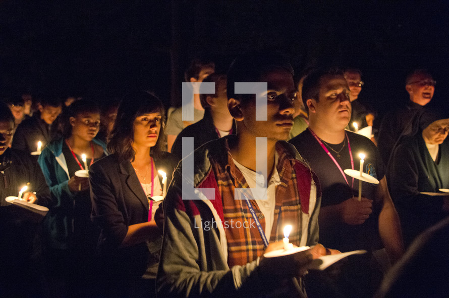 holding candles during a prayer vigil 