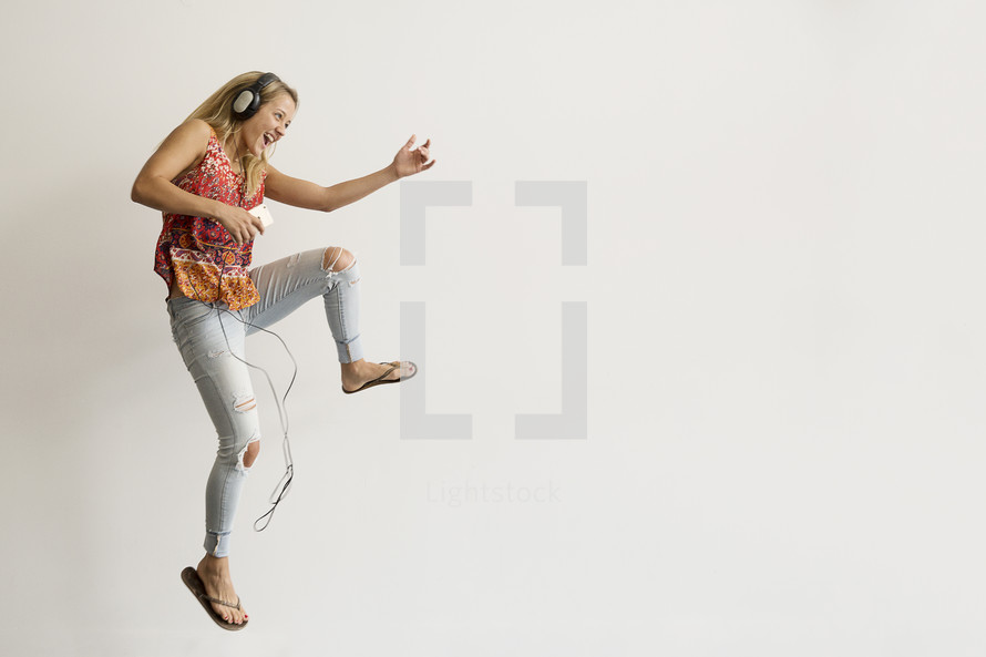 a teenage girl dancing to music 