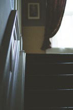 Darkened set of stairs in an old Italianate style home.