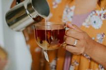 a woman pouring tea 