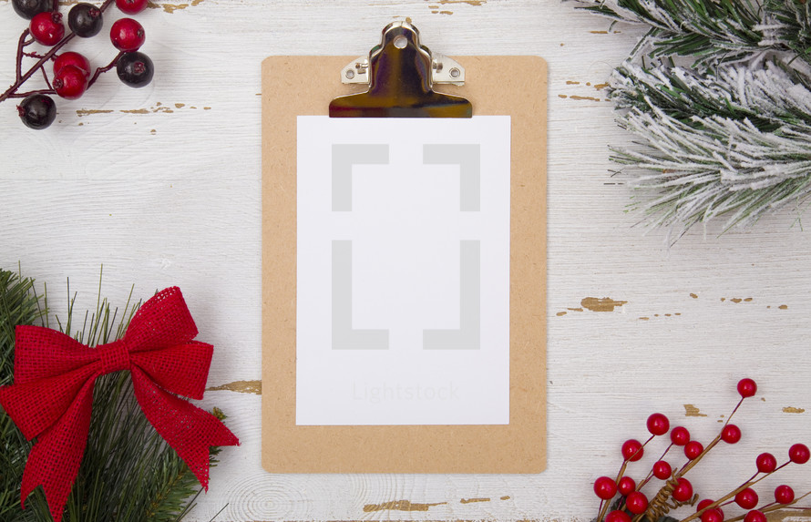 Christmas border and white paper on a clipboard 