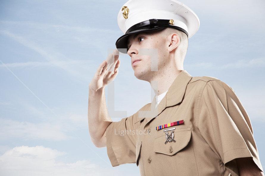Soldier in uniform saluting.