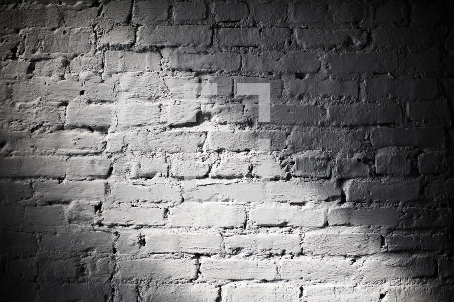 Beam of light on a white, brick wall.