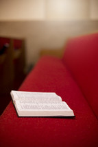 open Bible in a church pew 