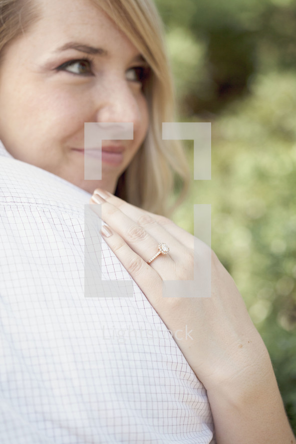 Woman wearing an engagement ring.
