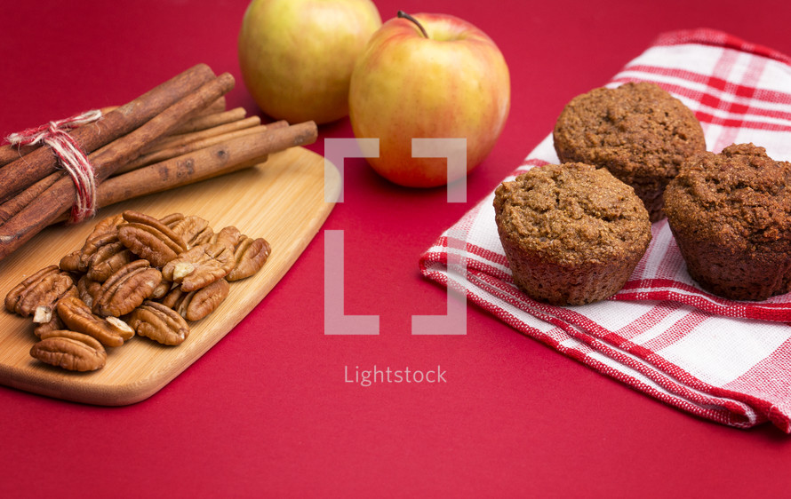 Apple Cinnamon Pecan Muffins on an Apple Red Background
