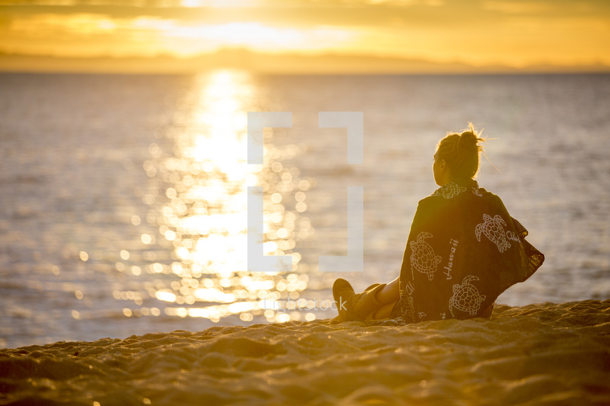 woman sitting on a beach 