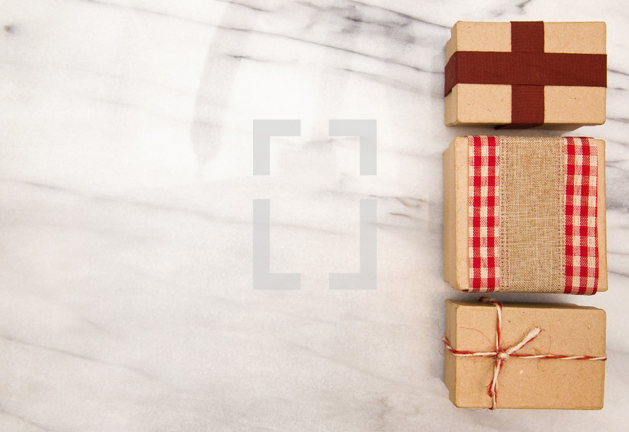 brown paper gifts on marble 
