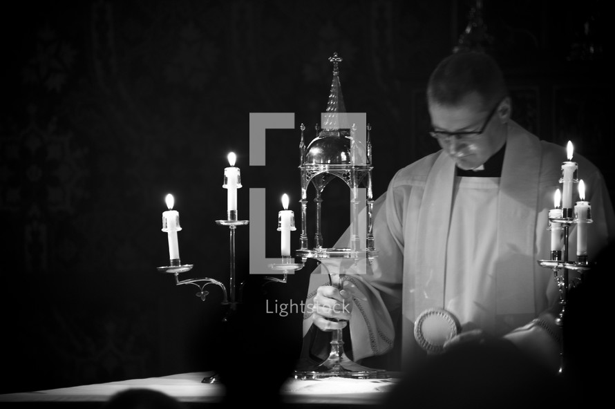 Priest preparing communion at an altar 