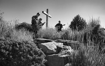 musicians playing outdoors standing around a cross