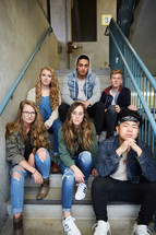 group of teens sitting on steps 