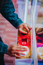 teen playing an arcade game 