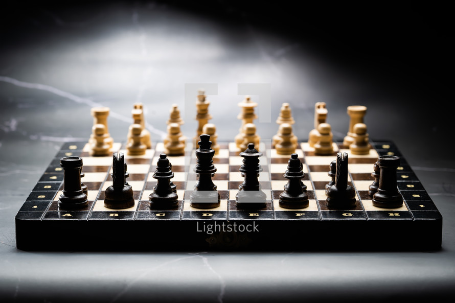 chess pieces on wooden chessboard before party competition. Board strategy game. Teamwork, success business, intelligence sport concept.
