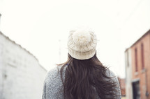 back of a woman's head and wool cap
