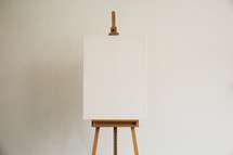 A blank canvas on an easel.