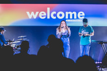 welcome sign and worship leaders 