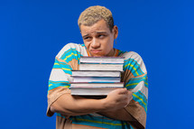 Lazy man student is dissatisfied with amount of books, homework in high school, blue background. 