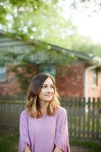a woman standing in a back yard 