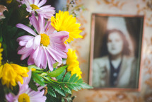 flower arrangement and old photograph of a woman 