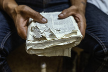 a man holding a very worn Bible 