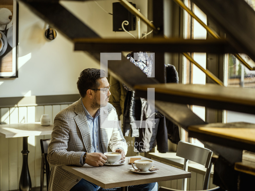 a man sitting at a coffee shop 