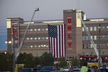 American flag hanging between two fire trucks in front of UNLV to honor the first responders of the Las Vegas shooting 