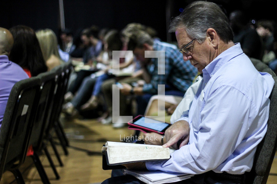 a man reading scripture during a worship service 