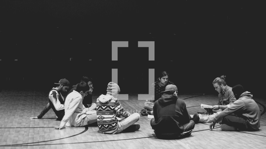young men sitting on the floor in a Bible study discussion 