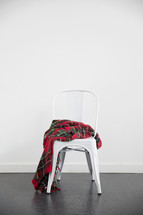 plaid blanket on a white chair 
