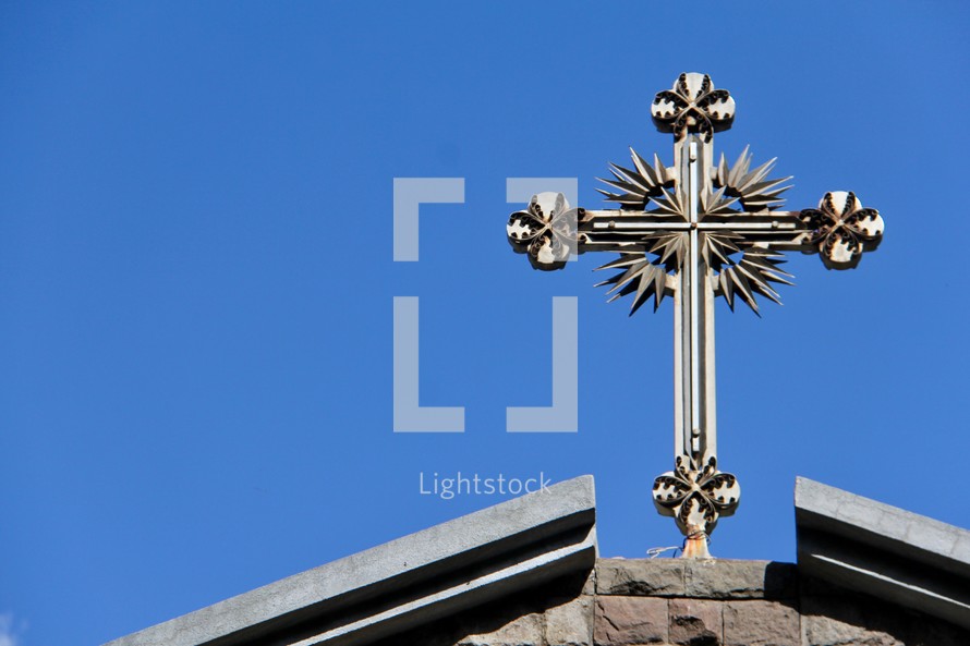 silver cross on a roof 