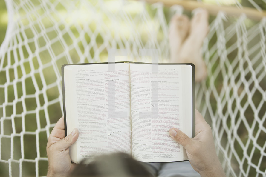 woman reading a Bible in a hammock