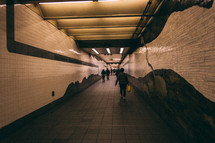 people walking through subway 