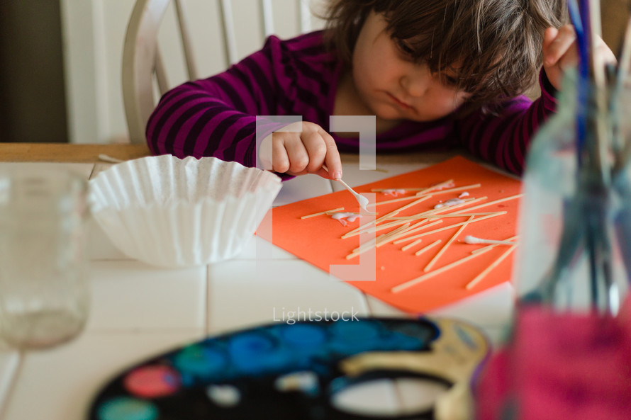 toddler girl making crafts 