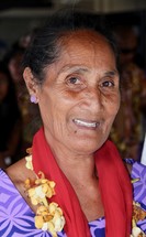 elderly woman wearing a lei