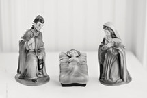 Nativity figurines -- Joseph, Mary, and Baby Jesus in a manger.