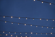 glowing lightbulbs on a string of lights at night 